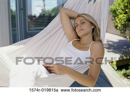 High angle view of a young woman lying in a hammock View Large Photo Image Stock Image - High angle view of a young woman lying in a hammock. Fotosearch