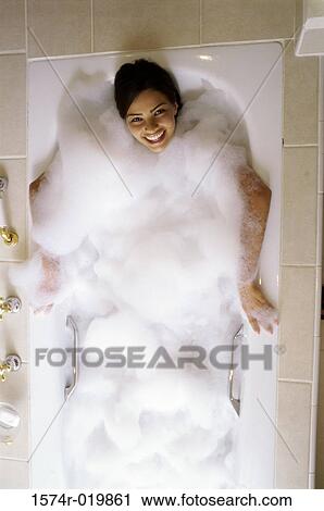 High angle view of a young woman taking a bubble bath View Large Photo Image Stock Image - High angle view of a young woman taking a bubble bath. Fotosearch