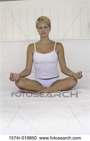 Portrait of a young woman sitting in a lotus position View Large Photo Image Stock Image - Portrait of a young woman sitting in a lotus position. Fotosearch