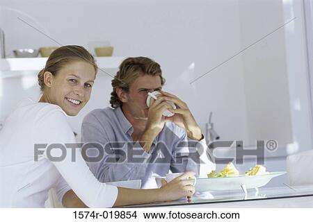 Young couple sitting at a breakfast table View Large Photo Image Picture - Young couple sitting at a breakfast table. Fotosearch