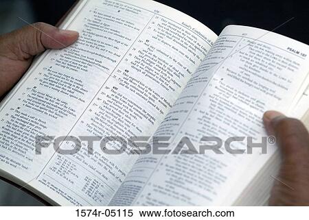 Close-up of a person holding an open Bible View Large Photo Image Stock Photography - Close-up of a person holding an open Bible. Fotosearch