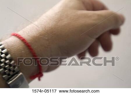 Stock Photo - Close-up of a person's hand wearing a protection string. Fotosearch