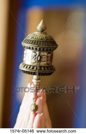 Close-up of a person's hands holding a Buddhist prayer wheel View Large Photo Image Stock Photograph - Close-up of a person's hands holding a Buddhist prayer wheel. Fotosearch