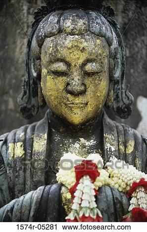 Stock Image - Close-up of a statue of Buddha, Wat Po, Bangkok, Thailand. Fotosearch