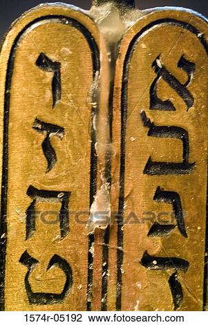 Stock Image - Close-up of Hebrew script on a menorah. Fotosearch