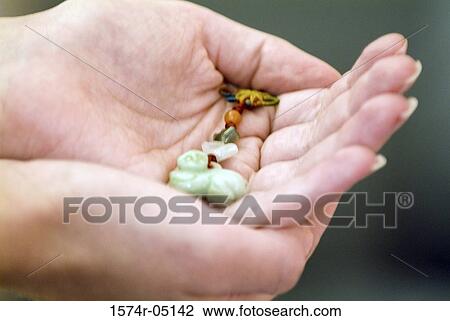 Close-up of human hands holding a good luck charm View Large Photo Image Stock Image - Close-up of human hands holding a good luck charm. Fotosearch