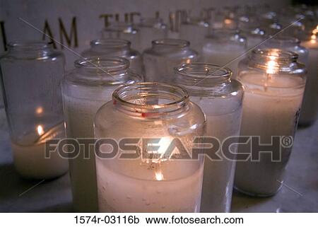 Close-up of lit candles in a church View Large Photo Image Stock Image - Close-up of lit candles in a church. Fotosearch