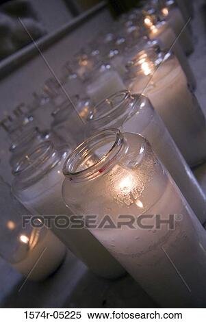 Stock Photography - Close-up of lit candles in a church. Fotosearch
