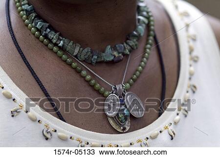 Stock Image - Close-up of Voodoo necklaces around a person's neck. Fotosearch
