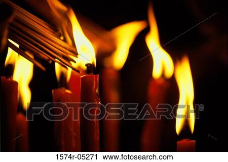 Incense sticks being lit from candles View Large Photo Image Stock Image - Incense sticks being lit from candles. Fotosearch