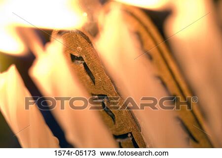 Stock Image - Menorah illuminated during Hanukkah festival. Fotosearch