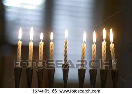 Stock Photograph - Menorah illuminated during Hanukkah festival. Fotosearch