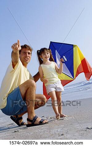Father and his daughter on the beach View Large Photo Image Stock Image - Father and his daughter on the beach. Fotosearch