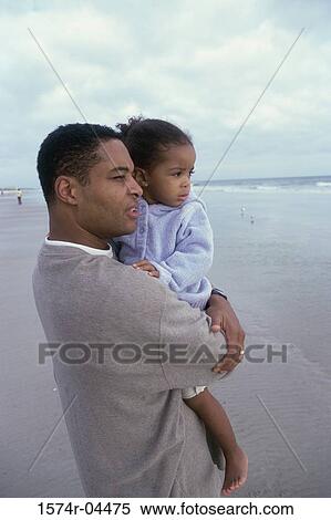 Father carrying his daughter on the beach View Large Photo Image Stock Photography - Father carrying his daughter on the beach. Fotosearch