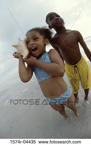 High angle view of a girl and a boy playing on the beach View Large Photo Image Stock Photography - High angle view of a girl and a boy playing on the beach. Fotosearch