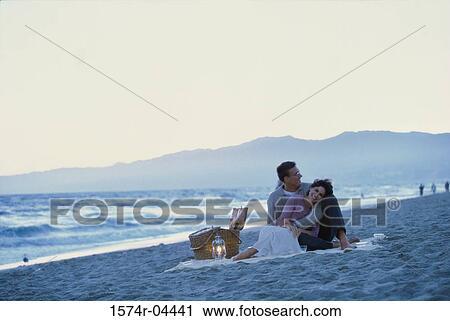 Mid adult couple sitting on the beach View Large Photo Image Stock Image - Mid adult couple sitting on the beach. Fotosearch