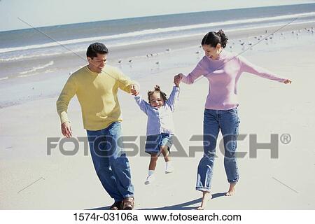 Parents playing with their daughter on the beach View Large Photo Image Stock Image - Parents playing with their daughter on the beach. Fotosearch