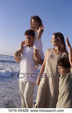 Parents walking with their son and daughter on the beach View Large Photo Image Stock Photo - Parents walking with their son and daughter on the beach. Fotosearch