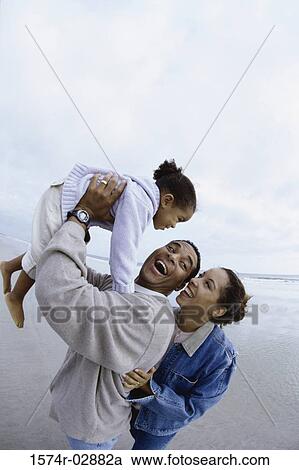 Parents with their daughter on the beach View Large Photo Image Stock Image - Parents with their daughter on the beach. Fotosearch