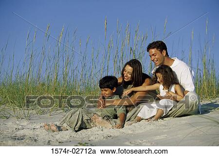 Parents with their son and daughter on the beach View Large Photo Image Stock Image - Parents with their son and daughter on the beach. Fotosearch