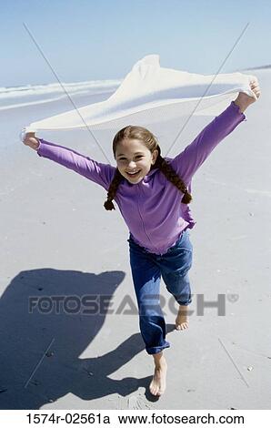 Portrait of a girl running on the beach View Large Photo Image Stock Image - Portrait of a girl running on the beach. Fotosearch