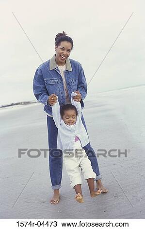 Portrait of a mother and her daughter playing together on the beach View Large Photo Image Stock Image - Portrait of a mother and her daughter playing together on the beach. Fotosearch