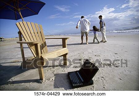 Rear view of parents walking with their daughter on the beach View Large Photo Image Stock Photo - Rear view of parents walking with their daughter on the beach. Fotosearch