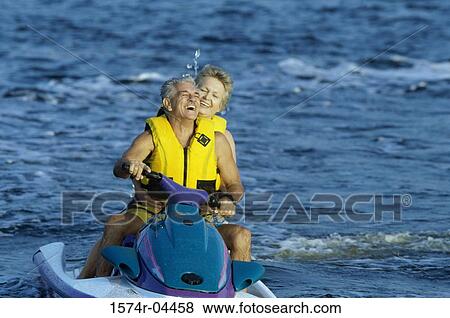 Senior couple riding a jet ski View Large Photo Image Stock Photo - Senior couple riding a jet ski. Fotosearch