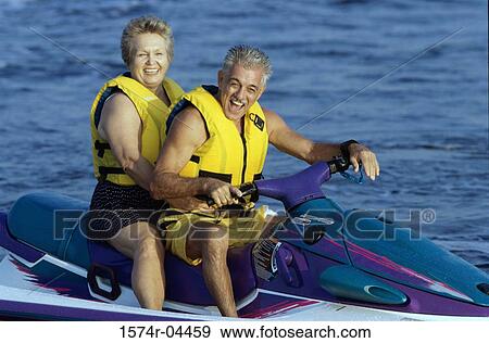Senior couple riding a jet ski View Large Photo Image Stock Photo - Senior couple riding a jet ski. Fotosearch