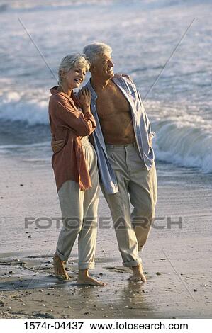 Senior couple walking on the beach View Large Photo Image Stock Photo - Senior couple walking on the beach. Fotosearch