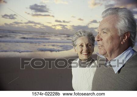 Side profile of a senior couple standing on the beach View Large Photo Image Stock Image - Side profile of a senior couple standing on the beach. Fotosearch