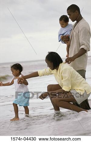 Side profile of parents with their son and daughter on the beach View Large Photo Image Stock Image - Side profile of parents with their son and daughter on the beach. Fotosearch