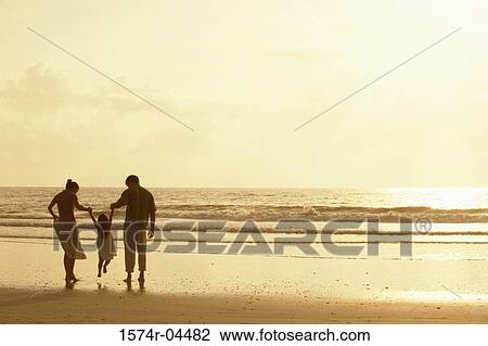 Silhouette of parents with their daughter on the beach View Large Photo Image Stock Image - Silhouette of parents with their daughter on the beach. Fotosearch