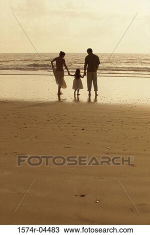 Silhouette of parents with their daughter on the beach View Large Photo Image Stock Image - Silhouette of parents with their daughter on the beach. Fotosearch