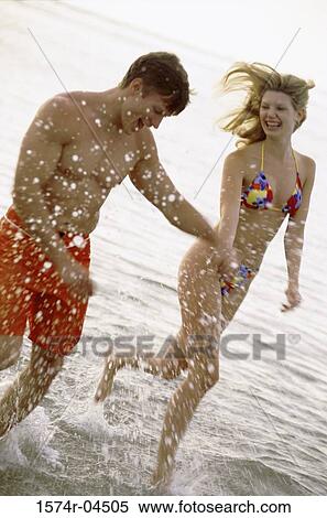 Young couple running on the beach View Large Photo Image Stock Photography - Young couple running on the beach. Fotosearch