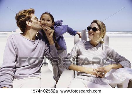 Young couple with their daughter on the beach View Large Photo Image Stock Image - Young couple with their daughter on the beach. Fotosearch