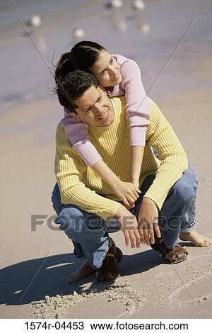 Young woman leaning against a young man on the beach View Large Photo Image Stock Image - Young woman leaning against a young man on the beach. Fotosearch