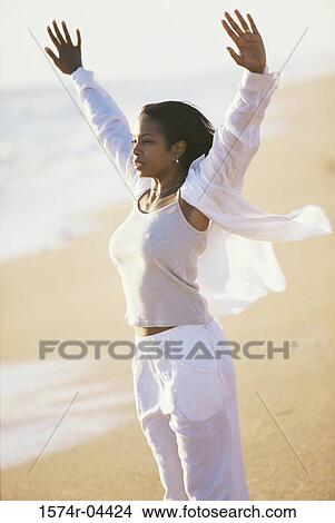 Young woman meditating on the beach View Large Photo Image Picture - Young woman meditating on the beach. Fotosearch