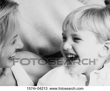 Stock Image - Close-up of a boy laughing with his mother. Fotosearch