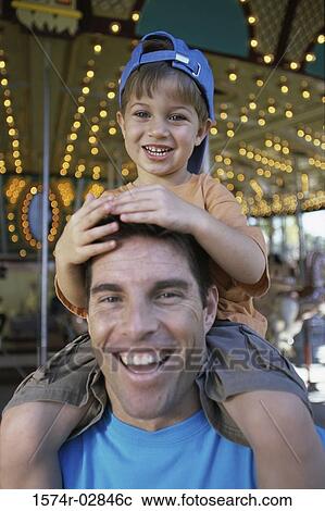 Close-up of a father carrying his son on his shoulders View Large Photo Image Stock Image - Close-up of a father carrying his son on his shoulders. Fotosearch