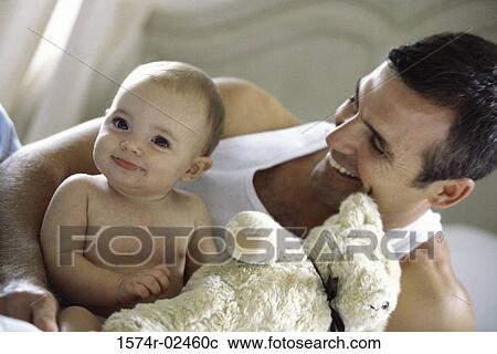 Close-up of a father holding his baby boy View Large Photo Image Stock Image - Close-up of a father holding his baby boy. Fotosearch