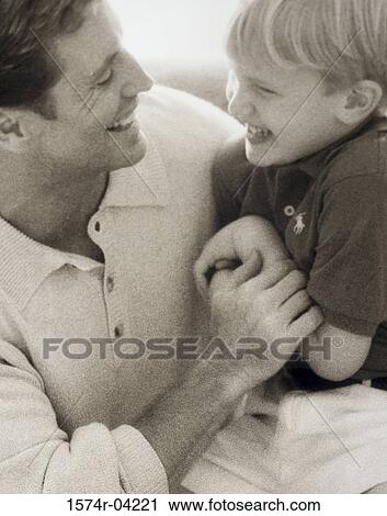 Close-up of a father laughing with his son View Large Photo Image Stock Image - Close-up of a father laughing with his son. Fotosearch