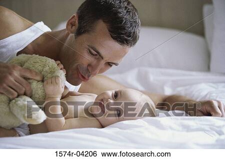 Stock Photograph - Close-up of a father playing with his baby boy. Fotosearch
