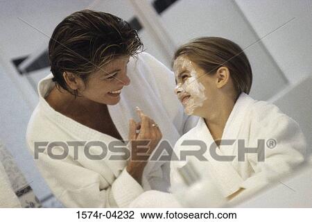 Close-up of a mother and her daughter in a bathroom View Large Photo Image Stock Image - Close-up of a mother and her daughter in a bathroom. Fotosearch