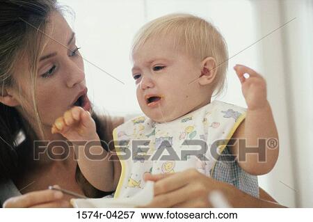 Stock Photo - Close-up of a mother feeding her son. Fotosearch