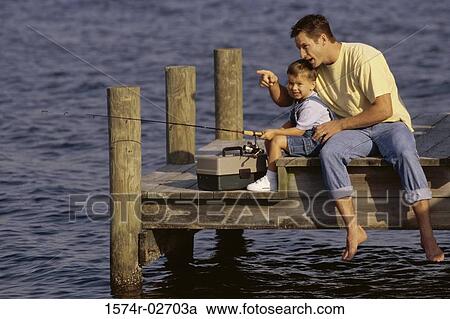 Father and his son sitting on a pier fishing View Large Photo Image Stock Image - Father and his son sitting on a pier fishing. Fotosearch