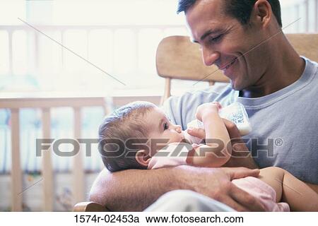 Father feeding his baby boy View Large Photo Image Stock Image - Father feeding his baby boy. Fotosearch