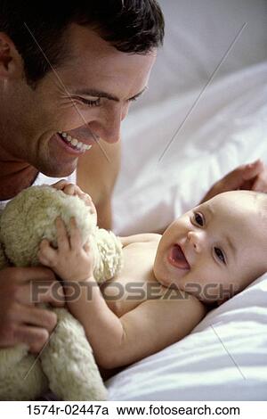 Stock Image - Father playing with his baby boy. Fotosearch