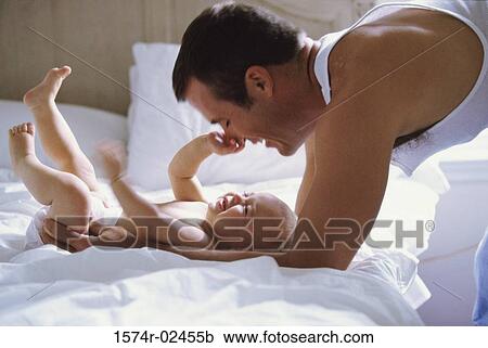 Father playing with his baby boy View Large Photo Image Stock Image - Father playing with his baby boy. Fotosearch