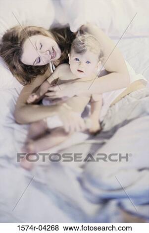 High angle view of a mother holding her baby boy View Large Photo Image Stock Photo - High angle view of a mother holding her baby boy. Fotosearch